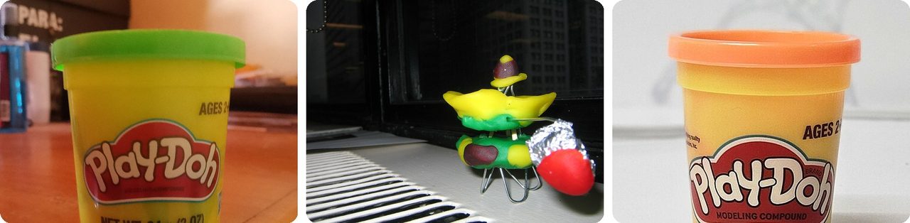 Tubs of Play-Doh and a child's Play-Doh creation